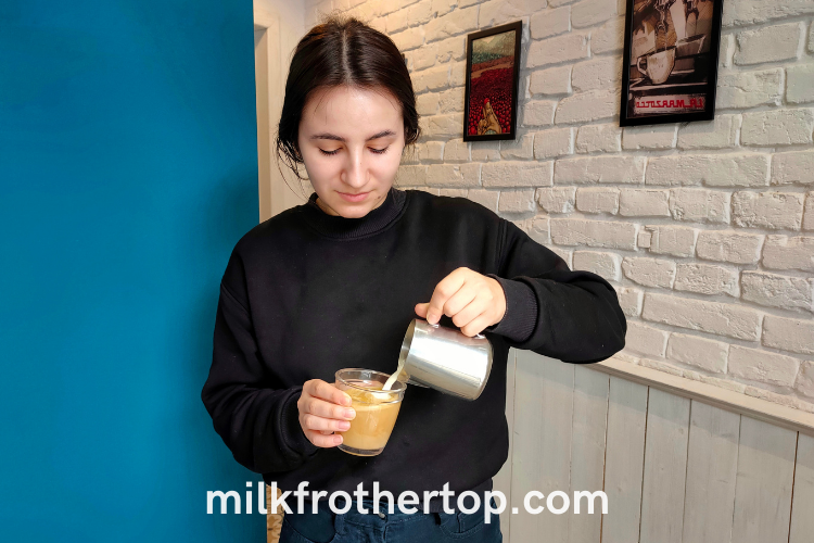 Adding frothed milk to espresso